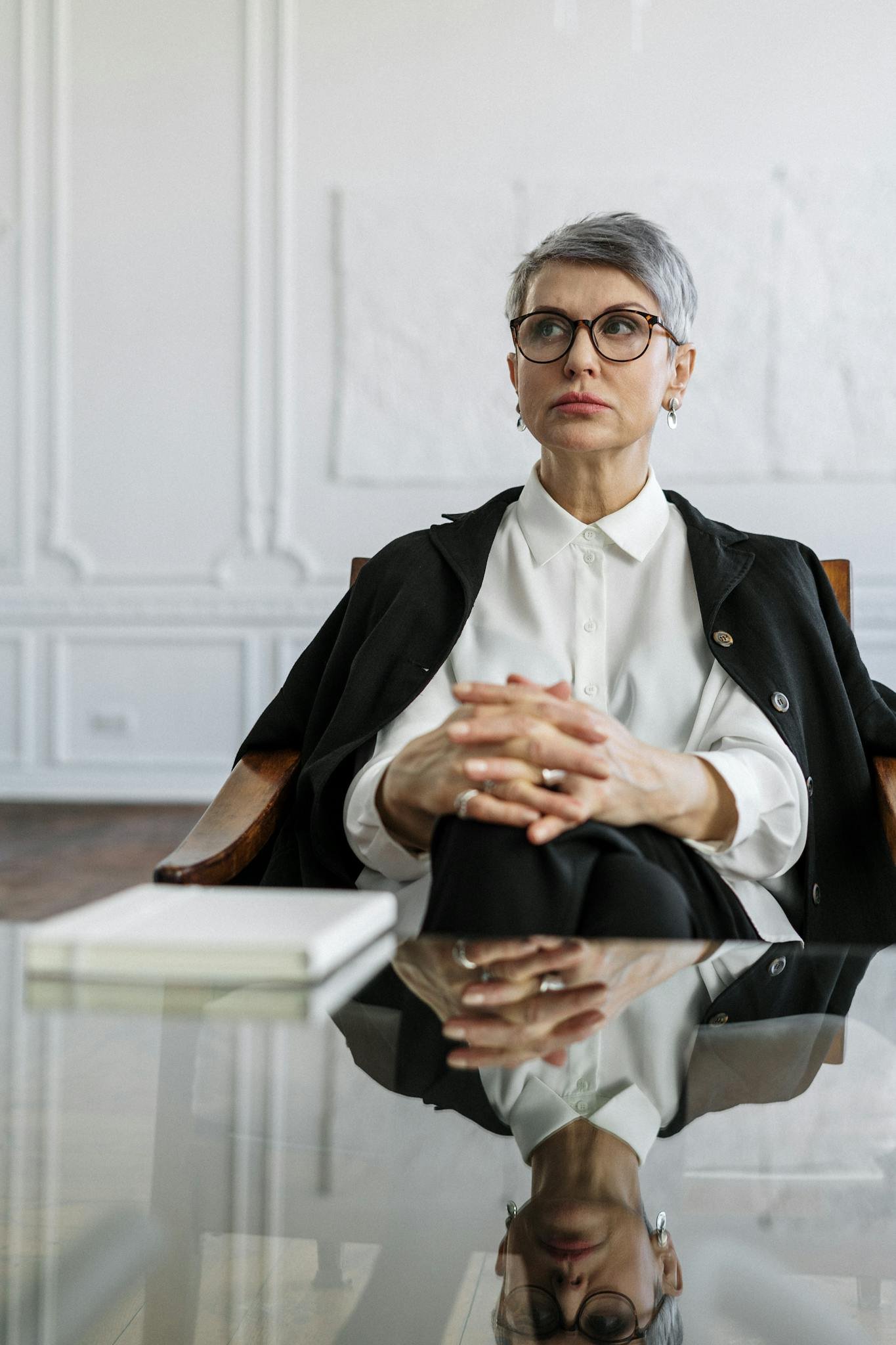 Man in Black Suit Jacket and White Dress Shirt Sitting on White Chair